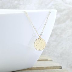 Give her the MOON! The peacefulness of the moon is captured in this hammered gold disc necklace, and it is the perfect addition to your collection. And the perfect gift for the woman who has everything. She will NEVER take it off!Gorgeous rich 1/2" (13mm) 14k gold fill disc is lightly hammered to create a unique textured look... every single one will be slightly different. This hangs from a 1.6mm gold filled cable chain to complete the look.  It can be worn alone, or layered with other pieces so Hammered Coin Necklace As Gift, Hammered Round Disc Coin Necklace As Gift, Hammered Coin Necklace Gift, Hammered Moon-shaped Jewelry As Gift, Hammered Moon-shaped Jewelry For Gifts, Dainty Hammered Coin Necklace As Gift, Minimalist Hammered Coin Necklace As Gift, Minimalist Hammered Coin Necklace Gift, Circle Moon Charm Necklace For Gift