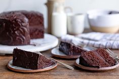 two slices of chocolate cake sitting on plates