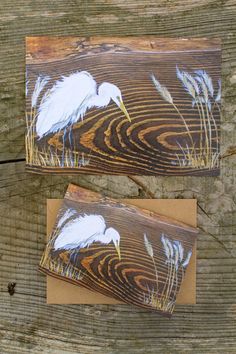 two cards with white birds painted on them