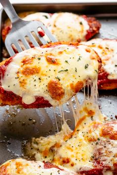 a spatula scooping melted cheese onto some pizza