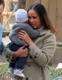 a woman holding a baby in her arms