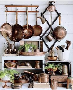 pots and pans are hanging on the wall