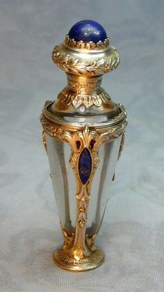 a blue and gold vase sitting on top of a table