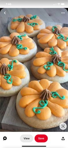 some cookies with icing on them sitting on top of a wooden table next to an instagram post