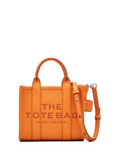 tangerine orange leather grained texture debossed logo to the front appliqué logo silver-tone hardware top zip fastening adjustable detachable shoulder strap two rolled top handles main compartment contrast lining This piece comes complete with a protective dust bag. Marc Jacobs Crossbody Bag, Medium Tote Bag, Marc Jacobs Tote, Small Tote Bag, Crossbody Tote Bag, Marc Jacobs Bag, Orange Bag, Medium Tote, Tote Bag Leather