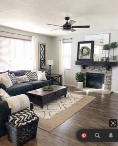 a living room filled with furniture and a fire place in the middle of the room