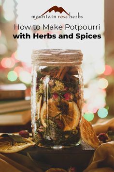 a jar filled with herbs and spices sitting on top of a table next to a book