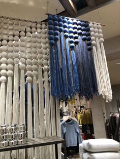 a store display with blue and white tassels hanging from the ceiling