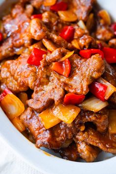 a white bowl filled with meat and vegetables