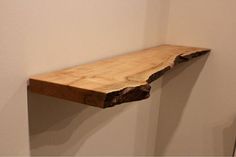 a wooden shelf sitting on the side of a wall