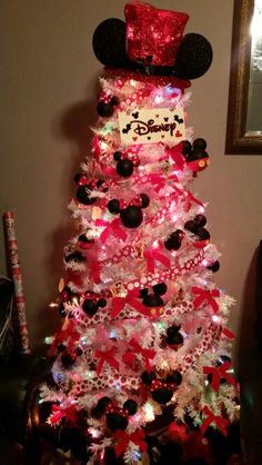 a christmas tree decorated with minnie mouse decorations