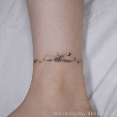 a woman's foot with a small wave tattoo on the side of her ankle