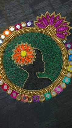 a woman's head with a flower in her hair is surrounded by multicolored beads