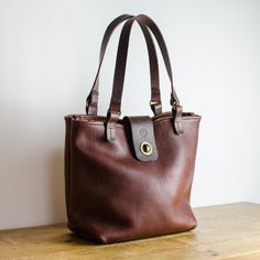 Leather Tote Bag Made from Chestnut Brown Full Grain OX Leather, All Hand-Stitched with waxed thread.  Designed for daily use, it works for both casual and more formal occasions. Each bag is made from OX leather and is finished with hand stitched Veg Tanned Leather handles and Clasp. The leather bag is the perfect size for use as an everyday carryall, as a stylish work bag or a weekend shopper, it's durable and designed to stand the rest of time. Item Details * Handmade in Manchester, England * Stylish Work Bag, Handmade Leather Tote Bag, Leather Computer Bag, Handmade Leather Tote, Leather Work Bag, Handmade Leather Bag, Bison Leather, Italian Leather Bags, Tote Bags Handmade