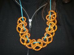 a woman wearing a necklace made out of pretzels