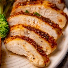 some meat and broccoli on a white plate