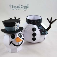 two snowmen made out of toilet paper on a white background with the words simply crafty next to them