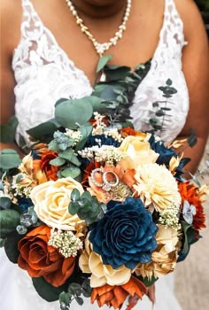 a bride holding a bouquet of flowers in her hands and wearing a necklace on her neck