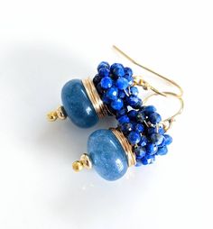 "Faceted navy Chalcedony earrings surrounded with tiny 2 mm unique lapis lazuli Stones. September birthday stone earrings. Gold filled earrings, Lapis jewelry Delicate and elegant earrings will complement any outfit. Hand created 14 carat gold filled ear wires are easy to wear for beautiful instant glamor! This earrings measure 1.25\" from the top of the ear wire to the bottom of the navy Chalcedony. Comes in organic gift box." Handmade Blue Cluster Earrings For Gift, Blue Hand Wrapped Earrings For Gift, Blue Hand Wrapped Earrings Gift, Hand Wrapped Blue Earrings Gift, Stone Earrings Gold, Birthday Stone, Stones Earrings, Organic Gifts, Lapis Jewelry