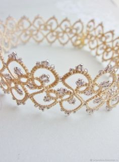 a gold tiara is shown on a white surface