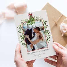 a person holding up a card with an image of a couple on it and tied to a string