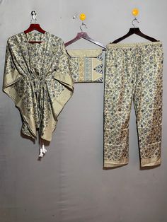 "kgncraft presenting this set of Indian Art Silk sari pajamas made up of a short kaftan, which is decorated with handmade stitches, and loose-fitting pants with an elastic waist, button detail. it can be worn at home and out. Art Silk fabric , floral printed night suit, it is done differently. it's not just nightwear, ideal for staying at home, sleeping, but also for lounge time and even parties. Short kftan and loose fit trousers / pants . with the holiday season just around the corner, it's th Silk Pajama Sets, Silk Pj Set, Dress Sleepwear, Nightwear Dress, Short Kaftan, Loose Fitting Pants, Bridesmaid Pyjamas, Silk Pajama, Cozy Pajamas