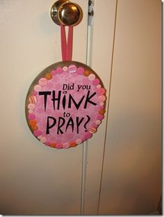 a sign that says did you think to pray? hanging on a door with two spoons