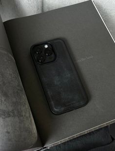 an iphone case sitting on top of a book