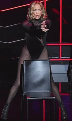 a woman sitting on top of a black chair