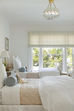 a bedroom with two beds and a chandelier hanging from the ceiling above them