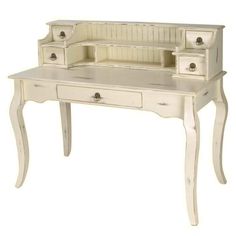 an antique white desk with drawers