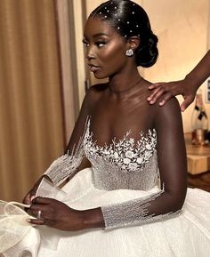 a woman in a white wedding dress is posing for the camera