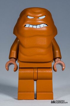 an orange lego character with big eyes