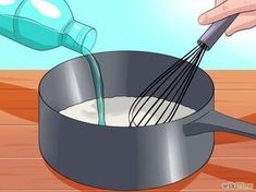 someone pouring milk into a pan with a whisk