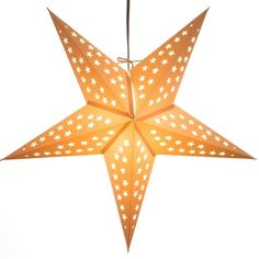 an orange paper star ornament hanging from a string with white stars on it