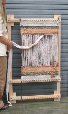 a woman standing next to a weaving machine