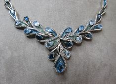 "From Macy's Fine Jewelry department, here's an exceptional sterling silver cocktail necklace set with teardrop shaped topaz stone in shades of blue. Each stone is mounted on an enameled leaf, and bordered by small diamonds. The entire piece measures 17\" in length, and is signed on the back and lobster claw clasp '925'. Thanks for looking." Blue Gem Necklace, Cocktail Necklace, Filigree Pendant Necklace, Crescent Necklace, Silver Cocktail, Big Diamond, Filigree Pendant, Blue Gems, Topaz Stone