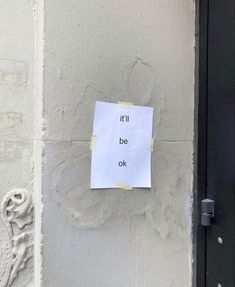 a piece of paper taped to the side of a building that says, i'd be ok