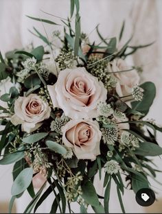 a bridal bouquet with pink roses and greenery