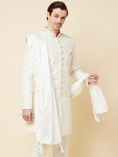 This Royal White Embroidered sherwani will instantly give an elegant look. Made from polyester cotton fabric, this 3 piece sherwani set features a white royal sherwani, front buttons fastening, designer cuff buttons, pocket square, and a mandarin collar. This white base sherwani has beautiful subtle gold Jaal thread-sequin embroidery work all over. It is paired with white churidar pants and matching dupatta. An ideal outfit for traditional & special events.

Size Chart For Men





	
	
					Men' Royal Sherwani, White Churidar, Embroidered Sherwani, Sequin Embroidery, Sequins Embroidery, Sherwani, Churidar, Embroidery Work, Over It