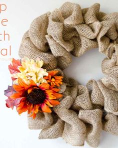 a burlap wreath with fall flowers on it and the words keep the faith real