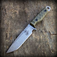 a large knife on top of a wooden table