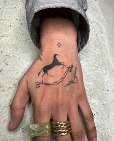 a person's hand with a dog tattoo on the left side of their palm