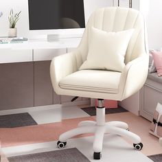 a white office chair sitting in front of a desk with a computer monitor on it