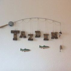 there is a sign that says tazdin and fish hanging on the wall above it