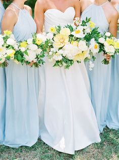 the bridesmaids are holding their bouquets with yellow and white flowers in them