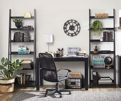 a black chair sitting in front of a desk with a clock on the wall behind it