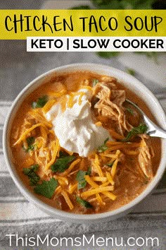 chicken taco soup in a white bowl with sour cream and cilantro