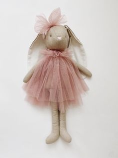 a stuffed animal with a pink tutu skirt and wings on it's body