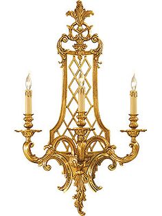 an ornate chandelier with three candles